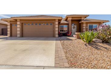 Charming single-Gathering home with a xeriscaped front yard and a spacious two-car garage at 11121 E Onza Ave, Mesa, AZ 85212