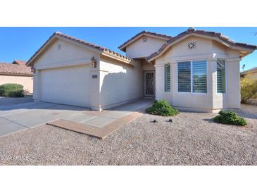 Charming single-story home with stucco exterior, desert landscaping, and an attached two-car garage at 2433 E Hancock Trl, Casa Grande, AZ 85194