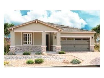 Charming single-story home featuring a two-car garage, stone accents, neutral paint, and desert landscaping at 40546 W Michaels Dr, Maricopa, AZ 85138