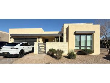 Contemporary stucco home with stone accents, desert landscaping, and modern design elements at 6151 N Las Brisas N Dr, Paradise Valley, AZ 85253