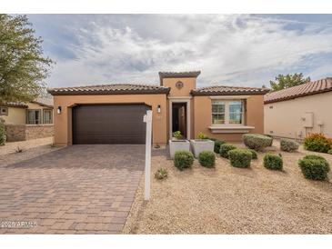 Charming single-story home featuring a tile roof, desert landscaping, and a two-car garage at 631 E Peach Tree St, Queen Creek, AZ 85140