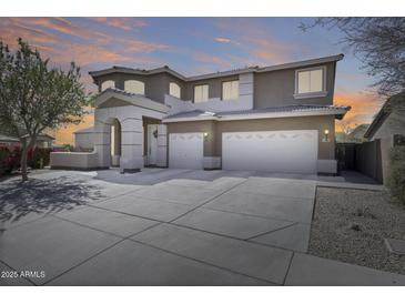 Beautiful two-story home with three-car garage and well-manicured front yard at 7317 W Southgate Ave, Phoenix, AZ 85043