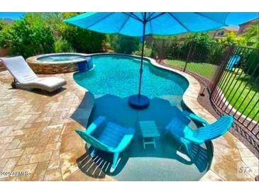 Inviting backyard pool and spa area, perfect for relaxation and entertaining at 7567 W Andrea Dr, Peoria, AZ 85383