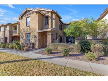 Charming two-story home featuring desert landscaping, stucco siding and a welcoming entryway at 857 S Osborn Ln, Gilbert, AZ 85296