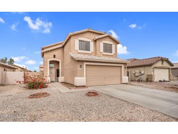 Charming two-story home with a two-car garage, desert landscaping, and beige stucco at 24848 W Kowalsky Ln, Buckeye, AZ 85326