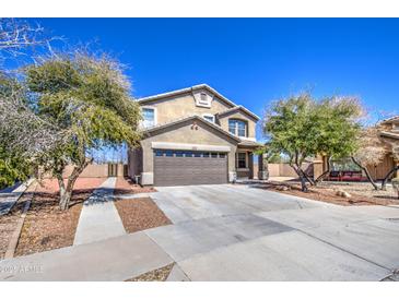 Charming two-story home with a well-maintained front yard, mature trees, and a two-car garage at 3102 W T Ryan Ln, Phoenix, AZ 85041