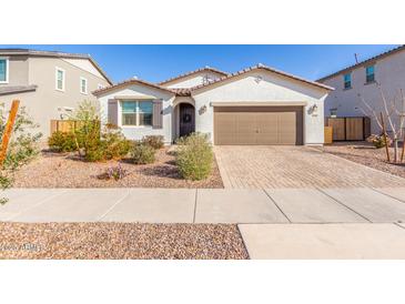 Charming single-story home showcasing desert landscaping and a paved driveway at 40160 W Hensley Way, Maricopa, AZ 85138