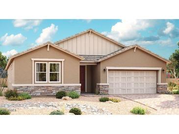 Charming single-story home featuring a two-car garage and well-manicured desert landscaping at 40562 W Michaels Dr, Maricopa, AZ 85138