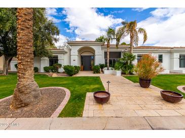 Beautiful home exterior with well-manicured lawn, mature trees, and an inviting front entrance at 5127 N 71St St, Paradise Valley, AZ 85253