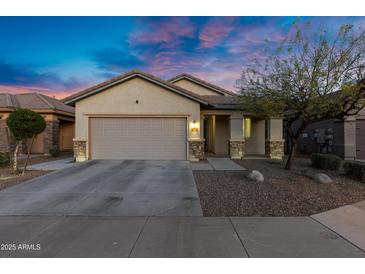 Charming single-story home with a neutral color scheme, well-kept landscaping and a two car garage at 8005 S 69Th Ln, Laveen, AZ 85339