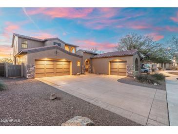 Stunning home with a tile roof, large driveway, and a three-car garage, illuminated by a gorgeous sunset at 8432 S 21St Pl, Phoenix, AZ 85042