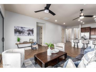 This is a bright living room features tile flooring, a ceiling fan, and stylish decor at 9041 E Ivyglen Cir, Mesa, AZ 85207