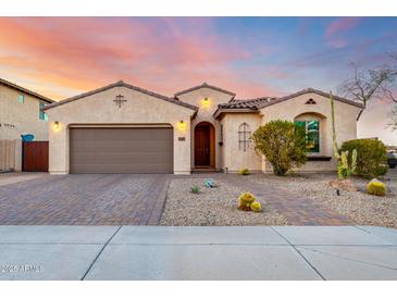 Charming single-story home with desert landscaping, paver driveway, and neutral stucco exterior at 9286 W Buckhorn Trl, Peoria, AZ 85383