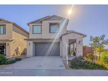 Inviting two-story home with a two-car garage and stone-accented entryway at 10013 E Trent Ave, Mesa, AZ 85212