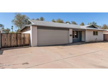 Charming single-story home with a two-car garage and well-maintained front yard at 1859 E Gemini Dr, Tempe, AZ 85283