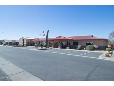 Tan building with desert landscaping, statues, American and Arizona state flags at 2263 N Trekell Rd # 81, Casa Grande, AZ 85122