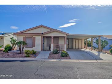 Cozy home featuring a covered carport, small porch, and xeriscaped yard at 2263 N Trekell Rd # 81, Casa Grande, AZ 85122