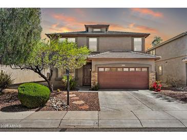 Charming two-story home showcasing a landscaped front yard and a two car garage at 6523 S 34Th Dr, Phoenix, AZ 85041