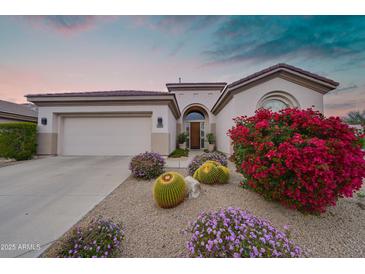 Charming home featuring a beautifully landscaped yard with vibrant desert flora at 7722 E Fledgling Dr, Scottsdale, AZ 85255