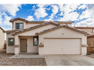 Charming two-story home with a large two car garage, neutral color scheme and low maintenance gravel yard at 833 W Cholla St, Casa Grande, AZ 85122