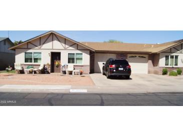 Charming home with a neatly landscaped front yard and attached two-car garage, offering curb appeal and convenience at 10112 N 96Th Ave # A, Peoria, AZ 85345