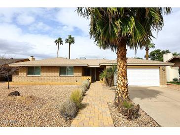 Charming home featuring a brick facade, complemented by desert landscaping and a welcoming walkway at 1966 E Pebble Beach Dr, Tempe, AZ 85282