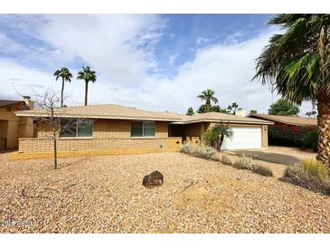Attractive single-story home with a well-maintained desert landscape and classic brick exterior at 1966 E Pebble Beach Dr, Tempe, AZ 85282