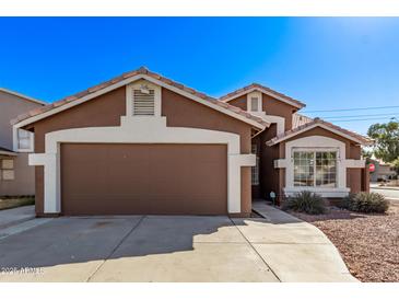 Charming single-Gathering home featuring a two-car garage and low maintenance desert landscaping at 19801 N 6Th Pl, Phoenix, AZ 85024