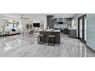 Open-concept kitchen with a center island, seating, and sleek gray cabinetry at 2818 E Malapai Dr, Phoenix, AZ 85028