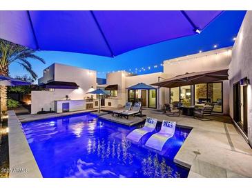 A resort-style pool area with tanning ledge, lounge chairs, and an outdoor kitchen at 31 E Bishop Dr, Tempe, AZ 85282
