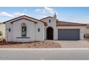 Charming single-story home with a tile roof, arched entry and low maintenance desert landscaping at 5779 N 207Th Ave, Buckeye, AZ 85396