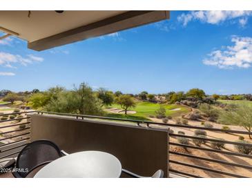 Relax on this balcony with a beautiful view of the lush golf course and clear blue sky at 15802 N 71St St # 311, Scottsdale, AZ 85254