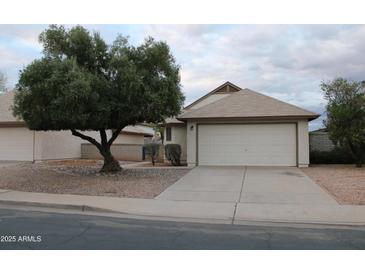Charming single-story home featuring a well-manicured front yard and a two-car garage at 1620 E Jacinto Ave, Mesa, AZ 85204