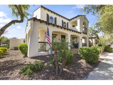 Charming two-story home with desert landscaping and a welcoming front porch perfect for relaxing at 20897 W Edith Way, Buckeye, AZ 85396