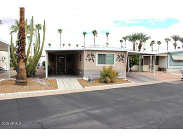 Charming mobile home with covered parking and desert landscaping, including mature cacti at 303 S Recker Rd # 89, Mesa, AZ 85206