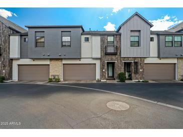 Charming townhomes showcasing a blend of modern design with gray siding and private garages at 3200 N 39Th St # 4, Phoenix, AZ 85018