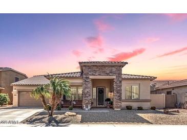 Charming single-story home features a stone facade, desert landscaping, and inviting entry way at 3285 E Phelps St, Gilbert, AZ 85295