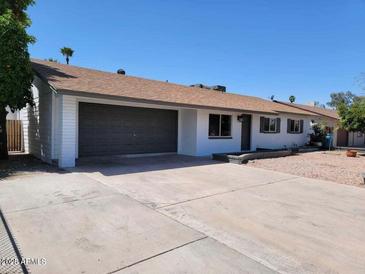 Charming single-story home featuring a spacious driveway and attached two-car garage at 4225 W Echo Ln, Phoenix, AZ 85051