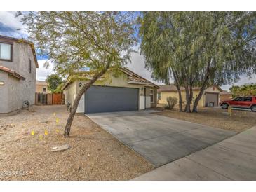 Charming single-story home featuring a two-car garage and low-maintenance desert landscaping at 44715 W Paitilla Ln, Maricopa, AZ 85139