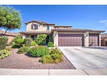 Charming two-story home featuring a three-car garage, landscaped yard, and covered porch at 549 W Sweet Shrub Ave, Queen Creek, AZ 85140