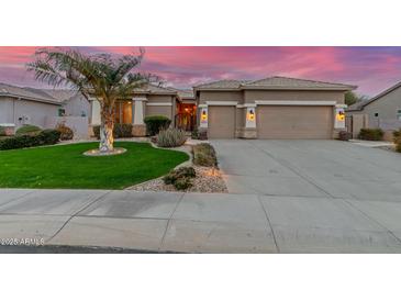 Charming home showcasing a lush front yard with a beautiful palm tree and manicured landscaping at 6751 S Callaway Dr, Chandler, AZ 85249