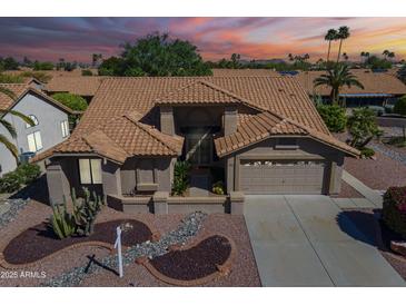 Charming single-Gathering home featuring a desert landscape, a two-car garage, and a tile roof at 9130 W Rimrock Dr, Peoria, AZ 85382