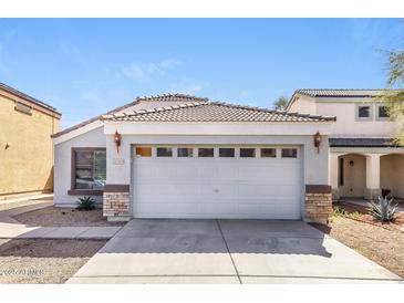 Charming single story home featuring a two-car garage and neutral color palette at 12325 W Charter Oak Rd, El Mirage, AZ 85335