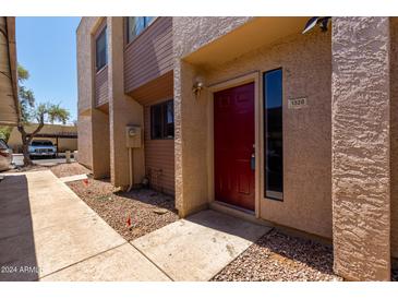 Charming townhouse exterior featuring a red front door and modern design elements at 1328 S Mckemy St, Tempe, AZ 85281