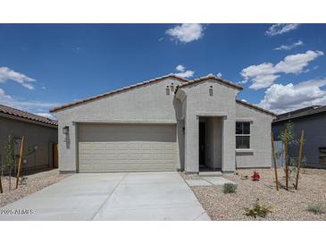 Single-story home showcasing a neutral color palette, xeriscaping, and a two-car garage under a bright blue sky at 2570 E Music Mountain Ave, Apache Junction, AZ 85119