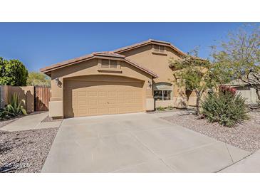 Single-Gathering home with a two-car garage, landscaped yard, and neutral color scheme, perfect for suburban living at 3116 W Folgers Rd, Phoenix, AZ 85027