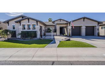 Charming single-story home featuring well manicured lawn, neutral tones, and covered front porch at 3373 E Oriole Way, Chandler, AZ 85286