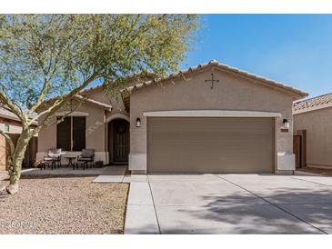 Charming single-story home with a two-car garage, desert landscaping, and covered front porch at 34969 N Open Range Dr, San Tan Valley, AZ 85144