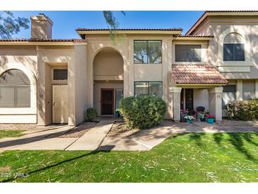 Inviting townhouse features a lush, green lawn and cozy front patios with charming decor at 500 N Roosevelt Ave # 102, Chandler, AZ 85226