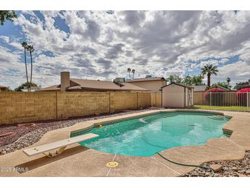 Spacious backyard features a swimming pool and mature trees at 5125 W Las Palmaritas Dr, Glendale, AZ 85302